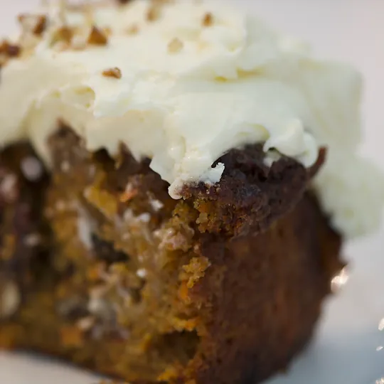 A slice of carrot cake with cream cheese icing